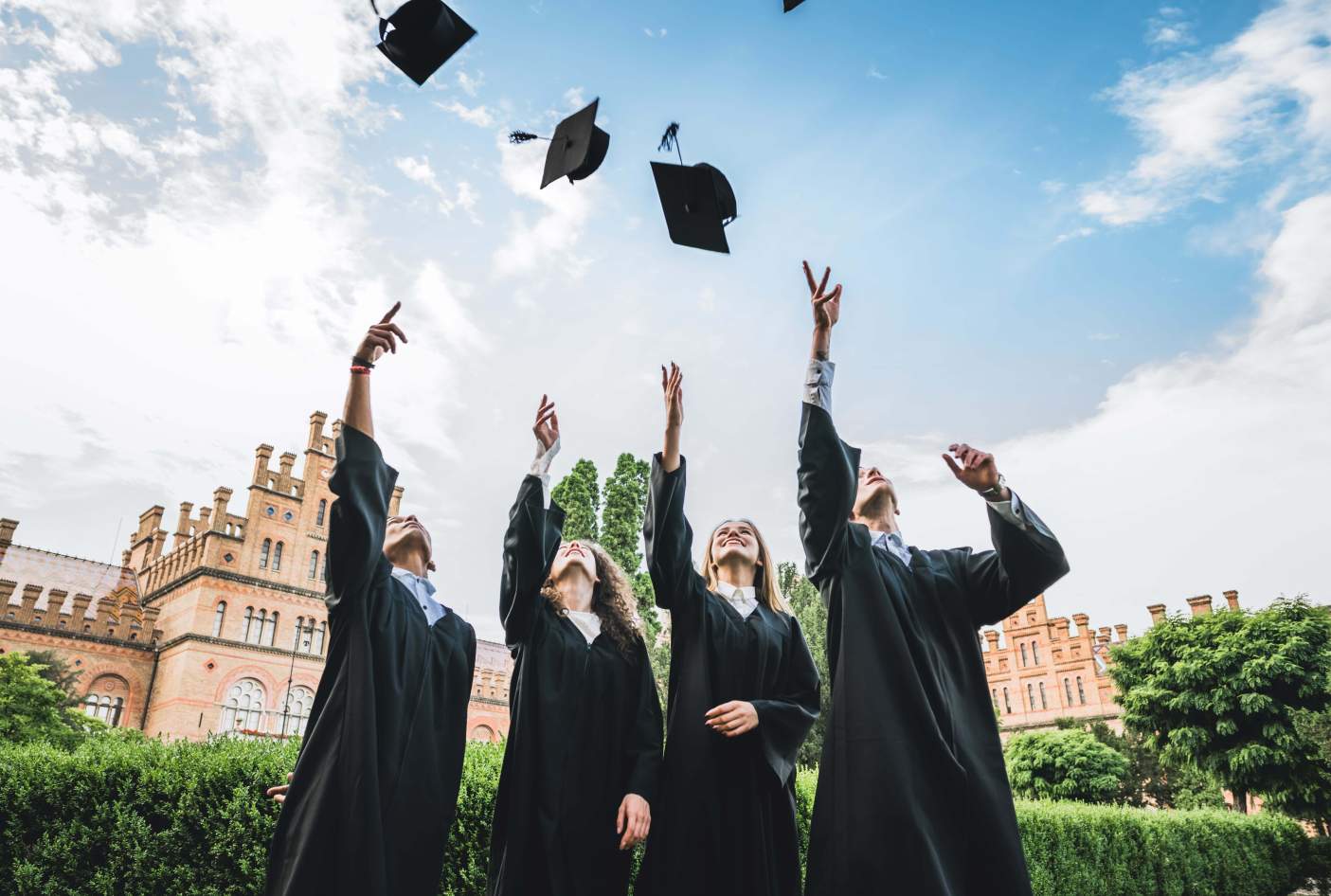 UC graduate wearing graduation gown set